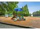 Community playground featuring multiple slides and play structures with a mulch ground cover at 107 W Point Trl, Woodstock, GA 30189