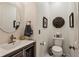 Charming powder room with modern fixtures, stylish mirror, and decorative wall accents at 107 W Point Trl, Woodstock, GA 30189