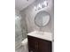 Modern bathroom with a walk-in shower, marble tiles, and a dark wood vanity with marble countertop at 2499 Peachtree Rd # 506, Atlanta, GA 30305