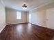 Large bedroom with sleek dark hardwood flooring, modern light fixture, and neutral paint at 2499 Peachtree Rd # 506, Atlanta, GA 30305