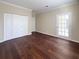 Hardwood flooring with a french door. The bedroom has a neutral color palette and ample closet space at 2499 Peachtree Rd # 506, Atlanta, GA 30305