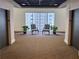 Hallway with two chairs and green potted plants overlooking exterior view through a large window at 2499 Peachtree Rd # 506, Atlanta, GA 30305