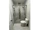 Walk-in shower with neutral tile, seamless glass door, and stylish fixtures, blending relaxation with modern design at 2499 Peachtree Rd # 506, Atlanta, GA 30305