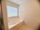 A relaxing bathtub with a window view, perfect for unwinding after a long day at 5421 Skylar Creek Ln, Buford, GA 30518