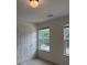 A bright bedroom features neutral carpeting and two double windows with green outdoor views at 5421 Skylar Creek Ln, Buford, GA 30518
