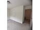 Bedroom with two doors, neutral carpet and walls, and a light fixture in a comfortable living space at 5421 Skylar Creek Ln, Buford, GA 30518