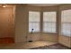 Bright bedroom featuring three windows for ample natural light and neutral carpet at 5421 Skylar Creek Ln, Buford, GA 30518