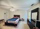 Bright bedroom featuring dark furniture, a ceiling fan, and neutral carpeting at 5421 Skylar Creek Ln, Buford, GA 30518