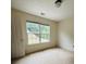 A simple bedroom features neutral carpeting and a double window with green outdoor views at 5421 Skylar Creek Ln, Buford, GA 30518
