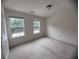 A bright bedroom features neutral carpeting and two double windows with green outdoor views at 5421 Skylar Creek Ln, Buford, GA 30518