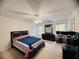 Spacious bedroom with ceiling fan and dresser, bathed in natural light from the large windows at 5421 Skylar Creek Ln, Buford, GA 30518
