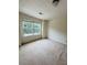 A bright bedroom features neutral carpeting and a double window with green outdoor views at 5421 Skylar Creek Ln, Buford, GA 30518