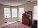 Bedroom featuring carpet, three windows, and a traditional-style wooden accent piece at 5421 Skylar Creek Ln, Buford, GA 30518