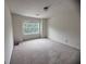 A bright bedroom features neutral carpeting and a double window with green outdoor views at 5421 Skylar Creek Ln, Buford, GA 30518