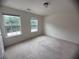 A bright bedroom features neutral carpeting and two double windows with green outdoor views at 5421 Skylar Creek Ln, Buford, GA 30518