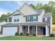 Beautiful two-story home with brick accents, covered porch, landscaped yard, and convenient two-car garage at 5421 Skylar Creek Ln, Buford, GA 30518