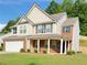 Beautiful two-story home featuring brick accents, vinyl siding, a front porch, and a well-manicured lawn at 5421 Skylar Creek Ln, Buford, GA 30518