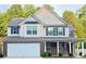 Charming two-story home featuring brick accents, a covered porch, and a well-maintained front yard at 5421 Skylar Creek Ln, Buford, GA 30518
