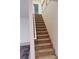 Carpeted stairway with a white banister connects the levels of this home at 5421 Skylar Creek Ln, Buford, GA 30518
