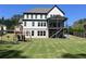 Large backyard featuring a playground and a covered back porch with stairs leading to the yard at 1952 Azalea Dr, Lawrenceville, GA 30043