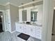 Bathroom with double vanity, modern fixtures, marble floors, and lots of storage at 1952 Azalea Dr, Lawrenceville, GA 30043