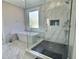 Modern bathroom with frameless glass shower, soaking tub, and marble accents at 1952 Azalea Dr, Lawrenceville, GA 30043