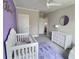 This Bedroom features a charming accent wall, dresser, a crib, and a chair creating a comforting atmosphere at 1952 Azalea Dr, Lawrenceville, GA 30043