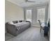Comfortable bedroom with a cozy daybed, desk area, soft carpet, and natural light, creating a relaxing space at 1952 Azalea Dr, Lawrenceville, GA 30043