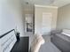 Well-lit bedroom with a daybed, desk, and doorway, creating a inviting space with access to other areas at 1952 Azalea Dr, Lawrenceville, GA 30043