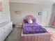 Cozy bedroom showcases a pink bed with purple accents, a dresser, and a charming decor for a haven at 1952 Azalea Dr, Lawrenceville, GA 30043