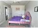 This bedroom features a cozy pink bed with purple bedding, white dresser, creating a delightful retreat at 1952 Azalea Dr, Lawrenceville, GA 30043