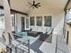 Relaxing covered patio with modern outdoor seating, a ceiling fan, and backyard views at 1952 Azalea Dr, Lawrenceville, GA 30043