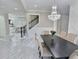 Bright dining room with modern chandelier, wainscoting and an open floor plan with marble floors at 1952 Azalea Dr, Lawrenceville, GA 30043