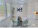 Bright dining area with modern lighting, large windows, and sleek glass table at 1952 Azalea Dr, Lawrenceville, GA 30043