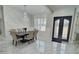 Dining room with large table and chairs under a chandelier, enhanced by marble floors at 1952 Azalea Dr, Lawrenceville, GA 30043