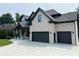 Stunning home featuring a three-car garage, brick accents, and a spacious driveway at 1952 Azalea Dr, Lawrenceville, GA 30043