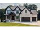 Charming two-story home with a brick facade, dark trim, a well-kept lawn, and an attached two-car garage at 1952 Azalea Dr, Lawrenceville, GA 30043