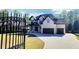 Gorgeous brick home with a black wrought iron fence and a well manicured lawn at 1952 Azalea Dr, Lawrenceville, GA 30043