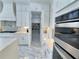 The kitchen boasts pristine white cabinets and modern stainless steel appliances for culinary excellence at 1952 Azalea Dr, Lawrenceville, GA 30043