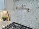Close-up of a chef's pot filler faucet against a decorative tile backsplash in the gourmet kitchen at 1952 Azalea Dr, Lawrenceville, GA 30043