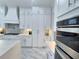 Well-equipped kitchen boasts sleek countertops, pot filler and stainless steel appliances for easy meal prep at 1952 Azalea Dr, Lawrenceville, GA 30043