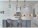 Open kitchen features a large island, stylish pendant lighting, and stainless steel appliances at 1952 Azalea Dr, Lawrenceville, GA 30043