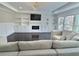 Inviting living room features a modern fireplace, built-in shelving, large windows, and plush sofa at 1952 Azalea Dr, Lawrenceville, GA 30043