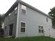 Back exterior view of the house with vinyl siding and sliding glass doors, and fenced yard at 215 Silver Spring St, Dallas, GA 30157