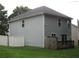 Rear view of home with vinyl siding, a small wooden deck, and a fenced-in backyard at 215 Silver Spring St, Dallas, GA 30157