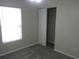 Cozy bedroom featuring neutral walls, carpet, a closet, and natural light from the window at 215 Silver Spring St, Dallas, GA 30157
