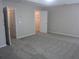Large bedroom featuring carpeted floors, neutral paint, and multiple closets for ample storage space at 215 Silver Spring St, Dallas, GA 30157