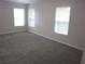 Neutral colored bedroom with carpeted flooring, offering a bright space with two large windows at 215 Silver Spring St, Dallas, GA 30157