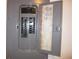 View of an electrical panel with multiple circuit breakers and safety labels at 215 Silver Spring St, Dallas, GA 30157