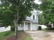 Charming two-story home with light blue siding, white trim, and a well-manicured lawn at 215 Silver Spring St, Dallas, GA 30157